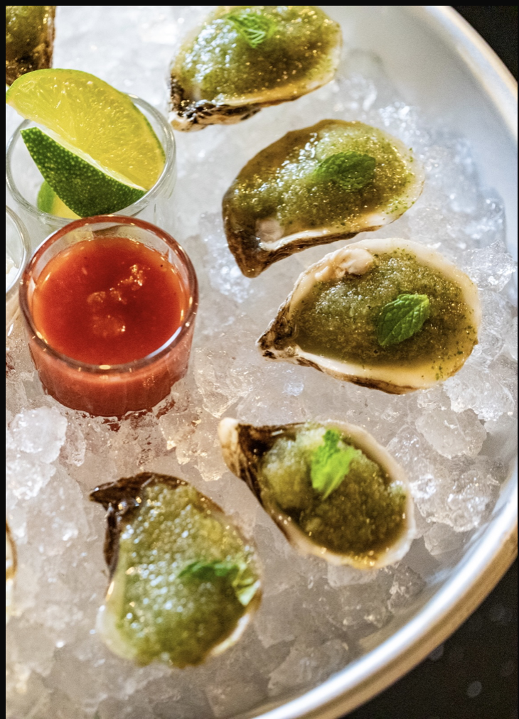 Freshly shucked oysters with cucumber mint granita, habanero tincture, cocktail sauce, and horseradish